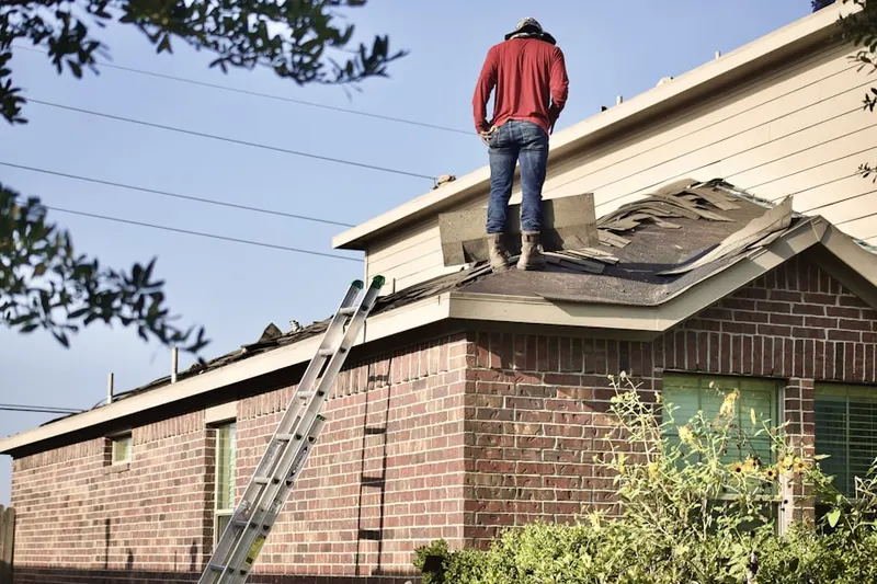 Professional roofer working on a residential roof in Sugar Creek Villas